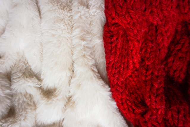 A close-up of a red and white scarf lying on a carpet..jpg